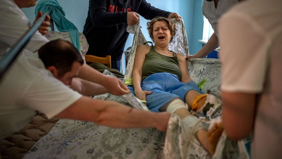 PHOTO: Olena Viter, 45, is transferred to a stretcher before undergoing surgery, at a hospital in Kyiv, Ukraine, May 10, 2022. The explosion that took Olena's leg also took her son, 14-year-old Ivan, a budding musician who played in a small orchestra.