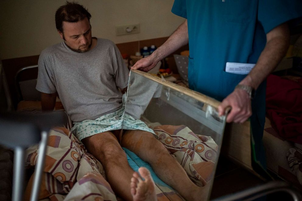PHOTO: Sasha Horokhivskyi gets mirror therapy to mitigate phantom pains at a hospital in Kyiv, Ukraine, April 28, 2022. Sasha lost his leg above the knee on March 22 after being shot by a territorial defense member who mistook him for a spy near his home