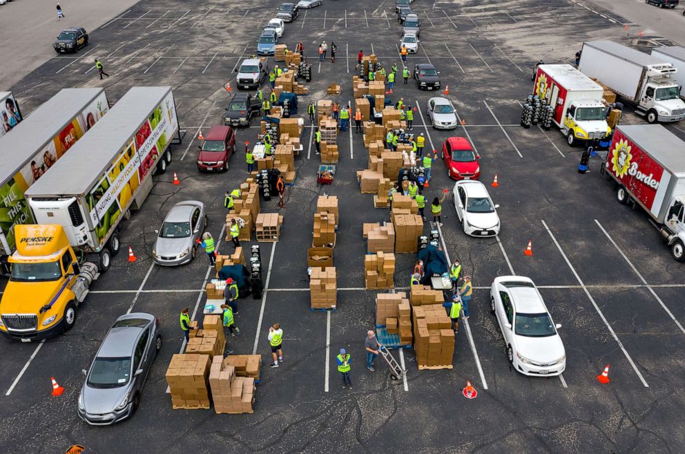 PHOTO: Volunteers for the Central Texas Food Bank load food into vehicles at a food distribution event in Austin, Texas, Nov. 23, 2020.