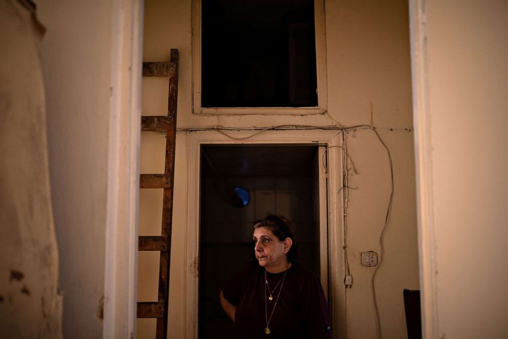 PHOTO: Qatfa Bassil stands by a doorway in her damaged home in Karantina, Beirut, Aug. 13, 2020.
