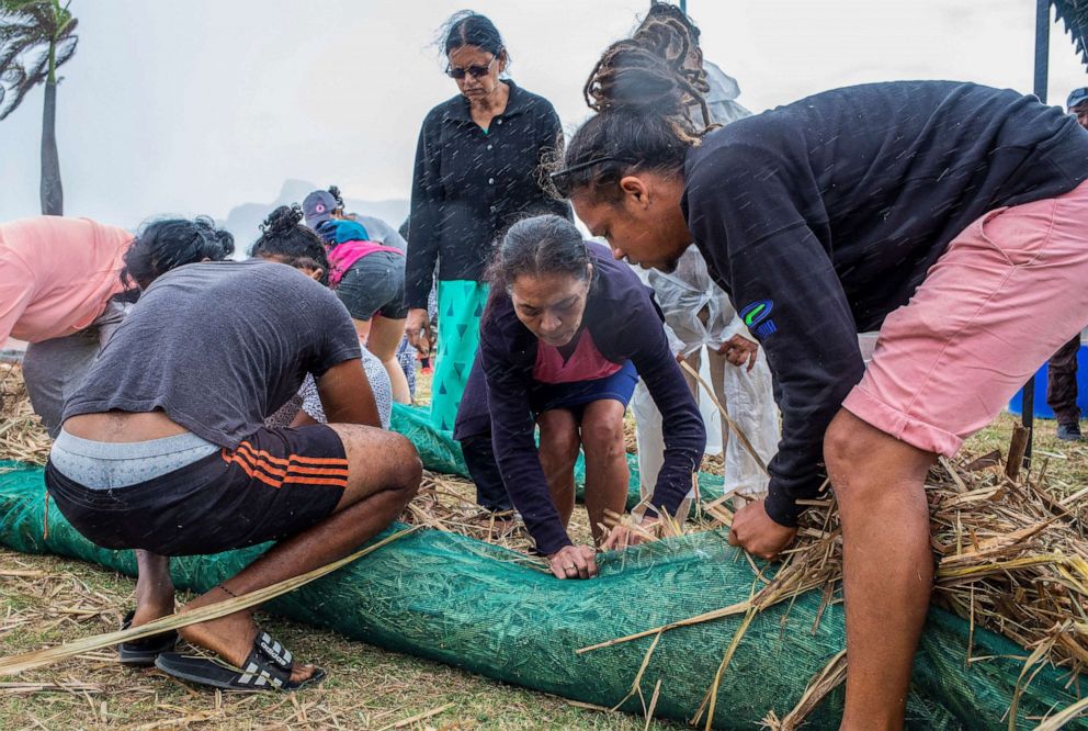 PHOTO: Volunteers make absorbent barriers of straw stuffed into fabric sacks to contain oil from the MV Wakashio, a Japanese owned Panama-flagged bulk carrier ship, Aug. 7, 2020.