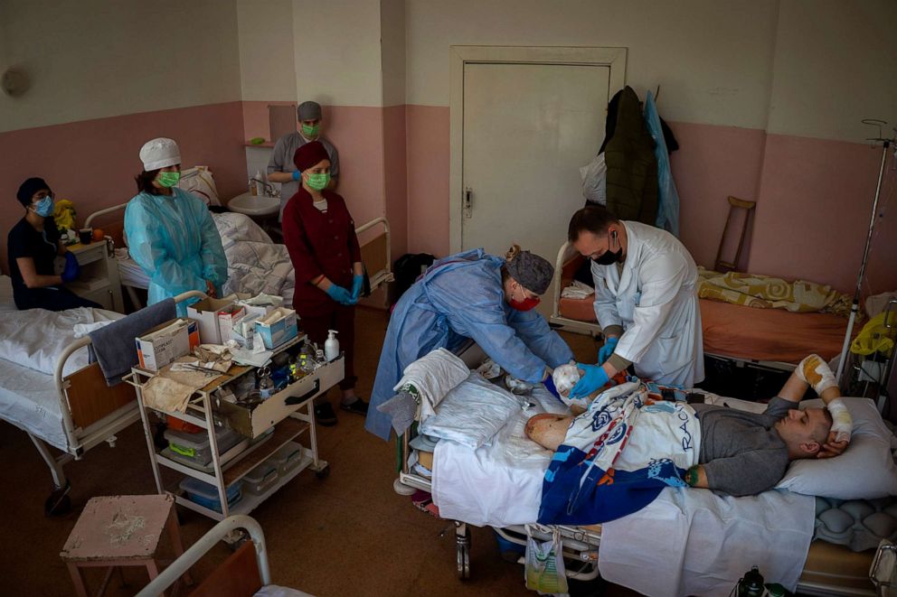 PHOTO: 22-year-old Anton Gladun has his wounds cleaned by doctors at the hospital in Cherkasy, Ukraine, May 6, 2022. A military medic, Gladun lost both legs and the left arm due to a mine explosion on March 27.