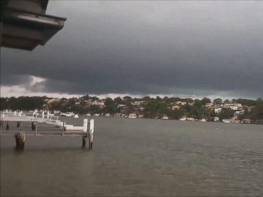 VIDEO: Two men narrowly avoided a lightning strike while filming a thunderstorm in Sydney's Oyster Bay.