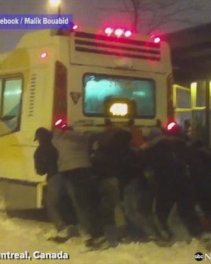 VIDEO: Montreal commuters band together to free a city bus stuck in the snow.