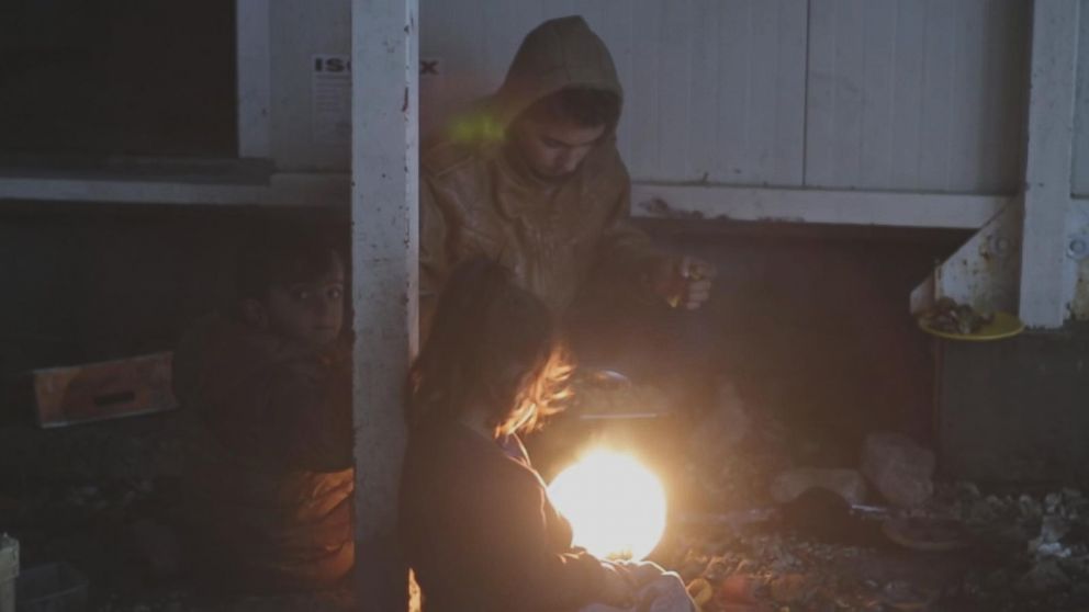 Fires are the center of life in the Moria refugee camp, as people gather around the flames to cook and try to stay warm.