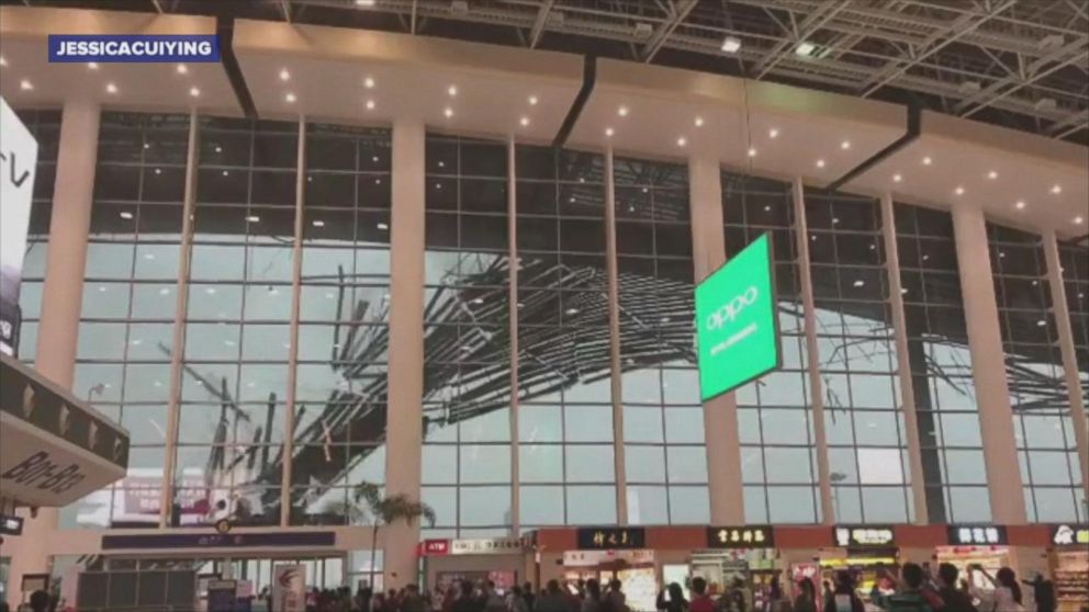 Travelers at the Nanchang Changbei International Airport in southeast China watch as part of the building's roof collapses.