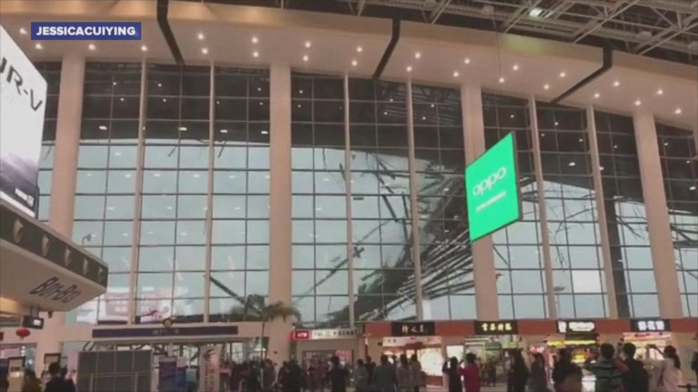 Travelers at the Nanchang Changbei International Airport in southeast China watch as part of the building's roof collapses.