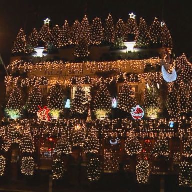 VIDEO: The Churchill Arms' 3-story display of nearly 100 trees and more than 21,500 Christmas lights has earned it the title of "most festive pub" in the United Kingdom.