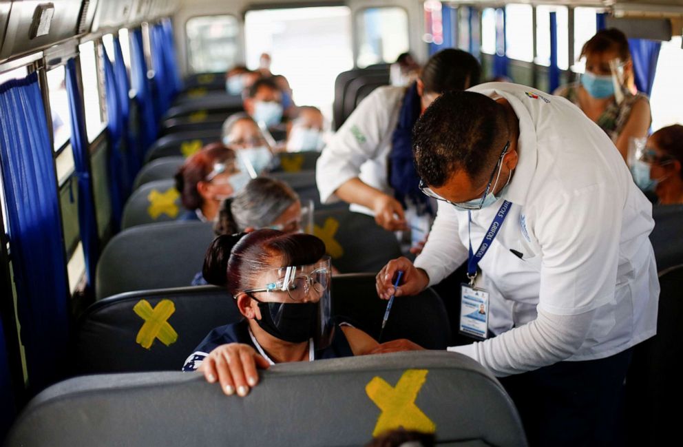 PHOTO: Onboard a bus, assembly factory workers in Ciudad Juarez, Mexico receive a dose of the Pfizer-BioNTech COVID-19 vaccine, May 24, 2021.