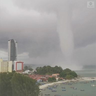 A waterspout was spotted churning as it made landfall on Malaysia's Penang island.