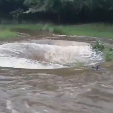 Floodwater surged into the Cup and Saucer waterfall at the Erddig estate, causing a spinning effect amid several flood alerts in the area.