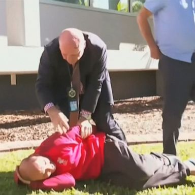 PHOTO: Police officer interrupts news conference to complete a textbook tackle of a suspect in Queensland, Australia.