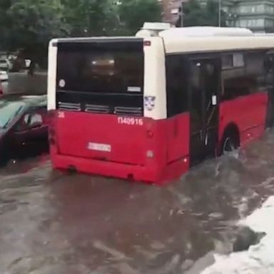 A bus drove through a street surrounded by floating vehicles in Belgrade, which saw rapid flooding and high water levels after heavy rainfall, limiting access to roads.