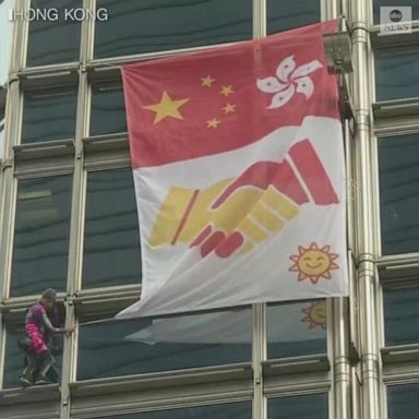 Alain Robert climbed Hong Kong's Cheung Kong building and unfurled a banner with "a message of peace."