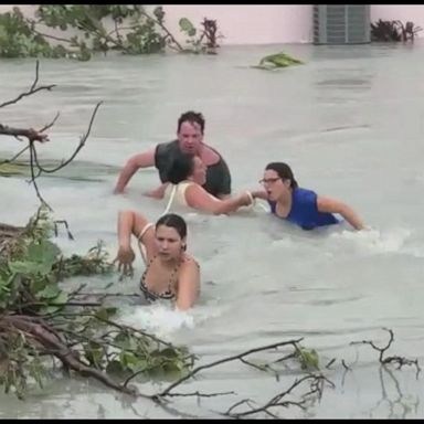 VIDEO: Current sweeps residents down flooded street in aftermath of Hurricane Dorian 