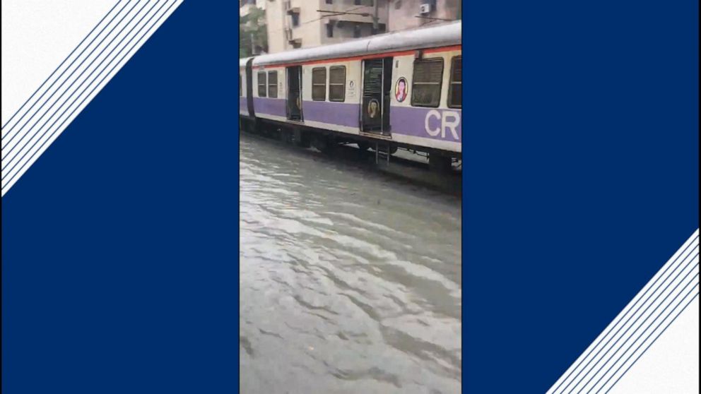 Video Crowded Mumbai train takes on flooded railway station - ABC News