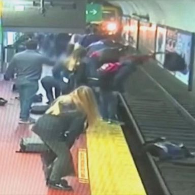 VIDEO: Bystanders help rescue woman who fell onto subway tracks