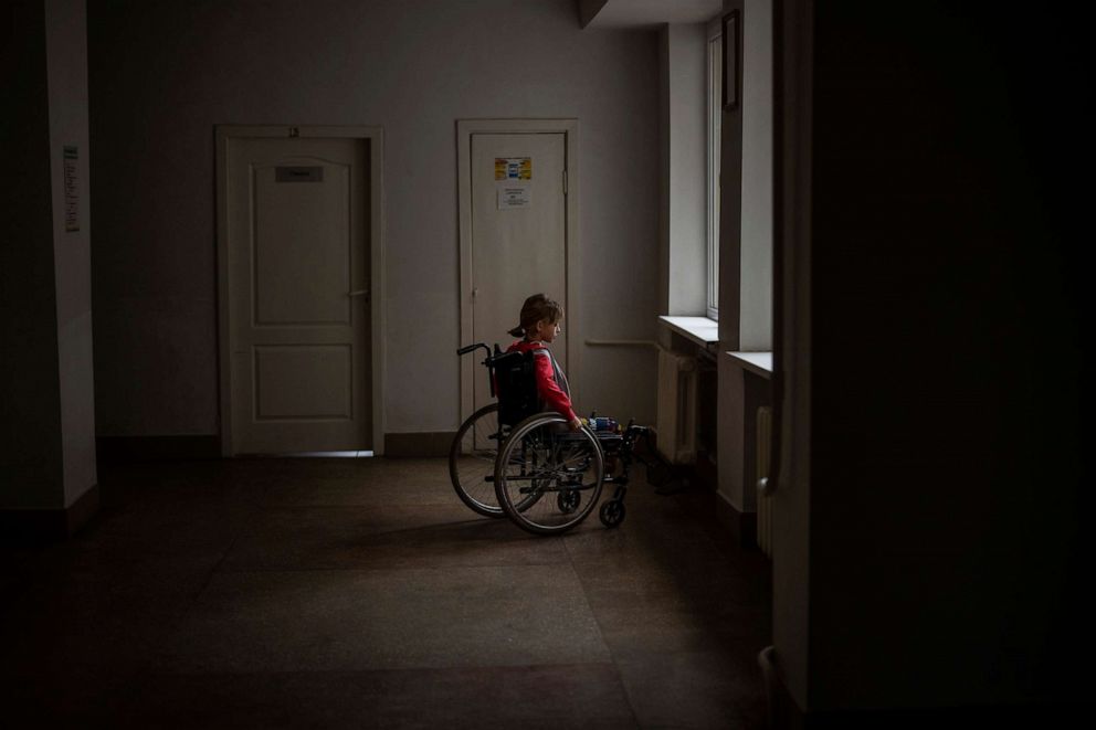 PHOTO: Yana Stepanenko, 11, sits next to the window on her wheelchair at a hospital in Lviv, Ukraine, May 13, 2022. Yana and her mother Natasha, 43, were injured April 8 during shelling at the Kramatorsk train station where they were trying to evacuate.