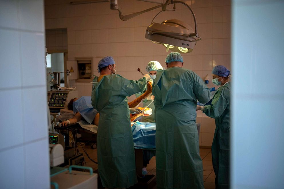 PHOTO: Olena Viter, 45, receives a surgery at a public hospital in Kyiv, Ukraine, May 10, 2022. Olena lost her leg and her 14-year-old son Ivan when bombs rained down on their village Rozvazhiv, in the Kyiv region, on March 14. 
