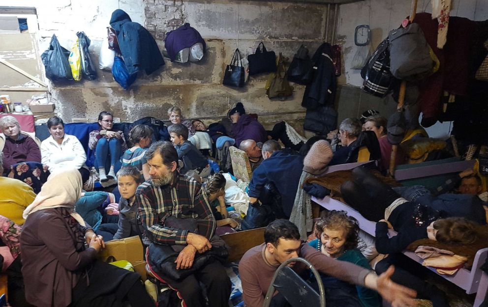PHOTO: Resident sit inside the basement of a school, a day after Russian troops left, in the village of Yahidne. Many continued to sleep in the basement because their houses had been destroyed. 
