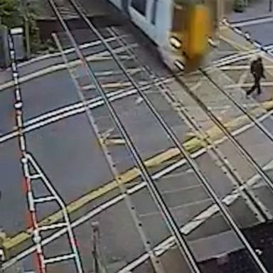 VIDEO: Man risks life to cross train tracks