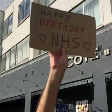 Health care workers and residents celebrate the NHS and its efforts during the COVID-19 pandemic.