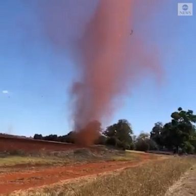 A local woman pulled over and captured the red dust devil as she was driving through the area.