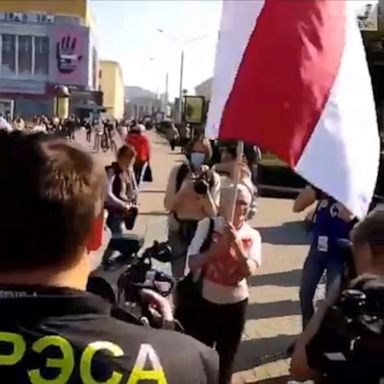 An officer wrestled a flag from a 73-year-old opposition protester during a women's march against President Alexander Lukashenko.