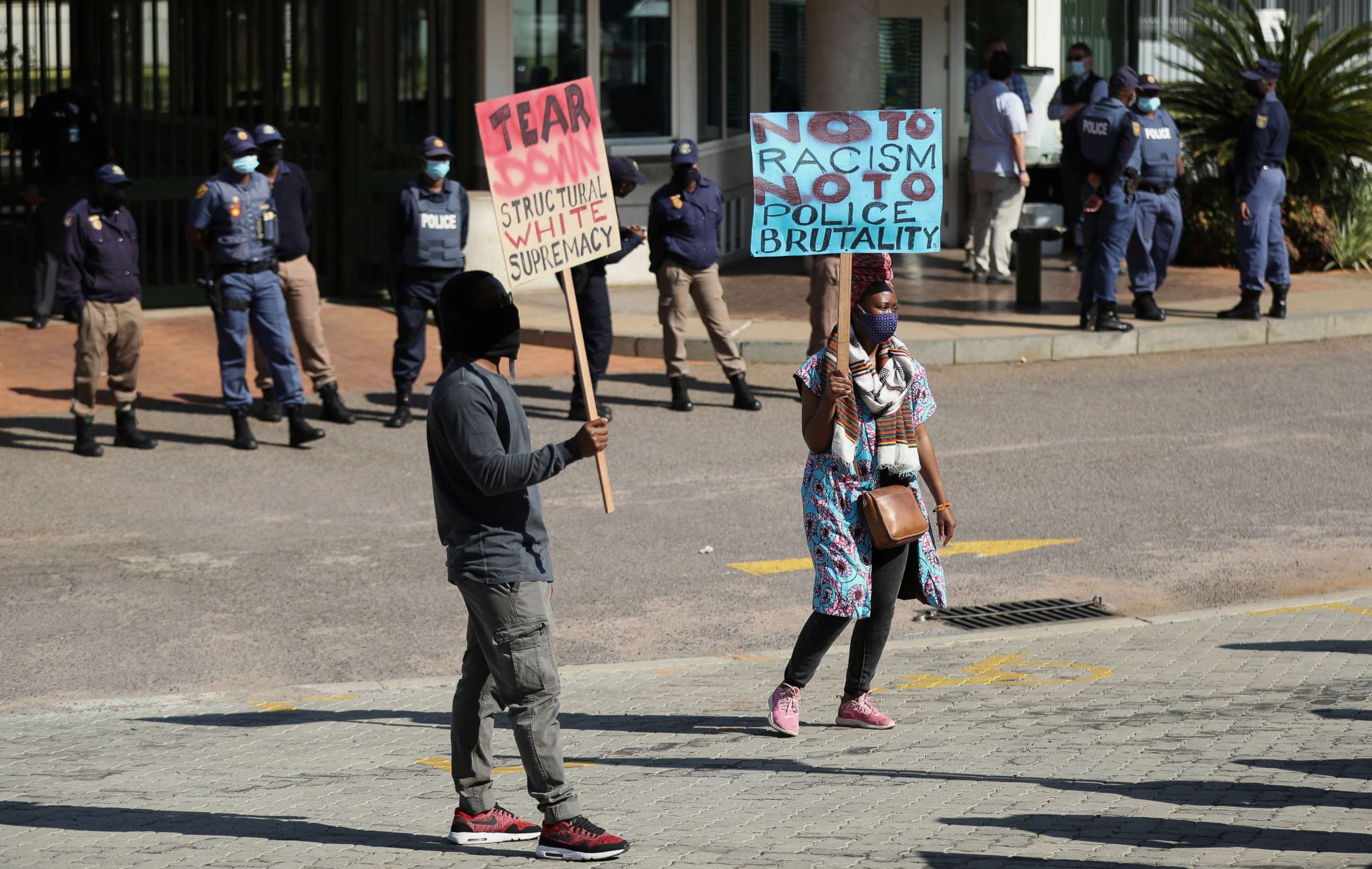 PHOTO: Protesters hold signs as they demonstrate against the death of George Floyd in the U.S., and Collins Khoza, who died after a confrontation with South African security forces, outside the U.S. embassy in Pretoria, South Africa, June 5, 2020.