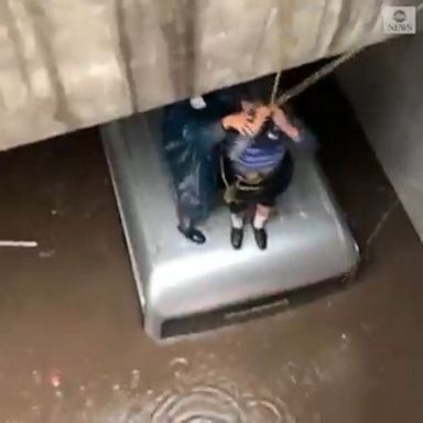 Rescuers found a man stranded on the roof of his vehicle as flash floods swamped the area.