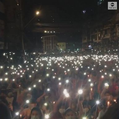 Protesters in Yangon sang and waved lights during a demonstration against last month's military coup.