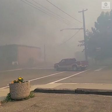 A dramatic video shows residents in Lytton, British Columbia, evacuating as a wildfire approached, raining down ash and blanketing streets with smoke.