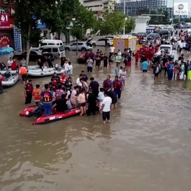 SWAMPED: Drone footage shows people rescued by an excavator from a Chinese city, in a region that has seen flash floods after a year's worth of rain fell in three days.