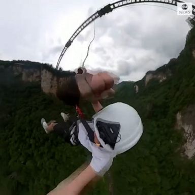 LOOK OUT BELOW: Daring tourists in China take the plunge by braving the world's highest bungee jump from a footbridge; an 850-foot drop. 