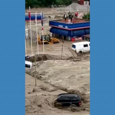 Severe flooding in northern Turkey swept away dozens of vehicles and left people stranded on a gas station roof. 