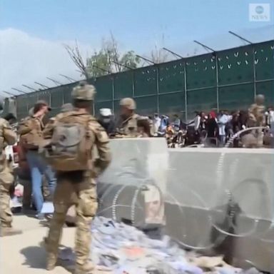 Turkish soldiers hand out water and food in blistering heat as thousands of Afghan families wait in line as the race to evacuate at Kabul airport continues.