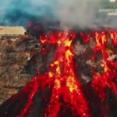 Spectacular drone footage captures lava streaming from the volcano in La Palma, Spain and spilling into the ocean.