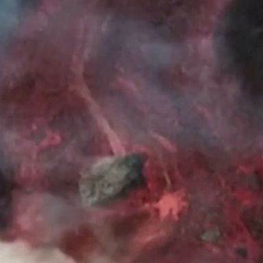 Drone footage shows huge blocks of red, hot lava rolling down La Palma volcano.