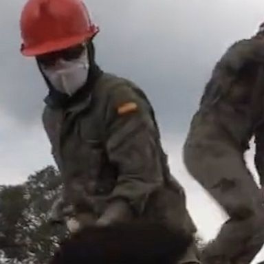 Members of the Spanish military used shovels, brooms and wheelbarrows to remove ash from rooftops on the island of La Palma, clearing them to avoid building collapses, following eruptions of the Cumbre Vieja volcano.