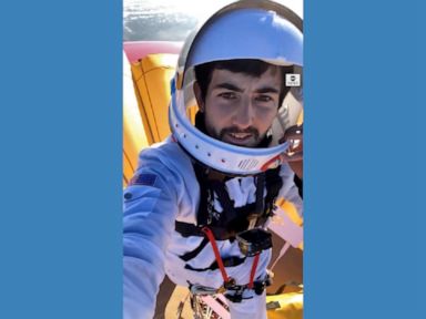 WATCH: Man sets record for standing atop hot air balloon