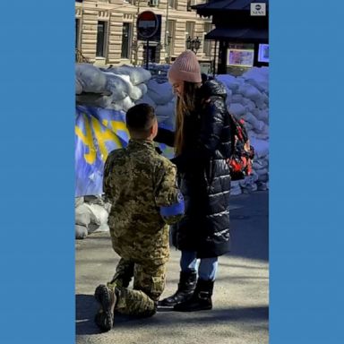 A Ukrainian soldier dressed in fatigues, got on one knee and proposed to his girlfriend in Odessa. 