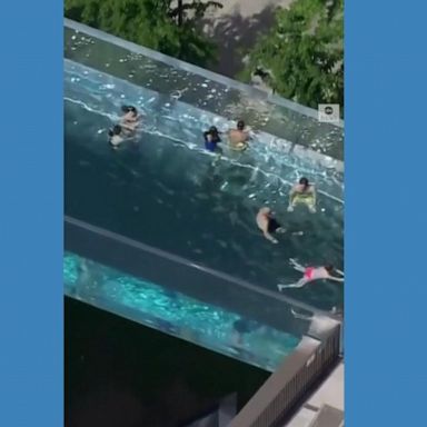 PHOTO: Suspended between two high-rise buildings, swimmers enjoy one of London’s most exclusive and unique swimming pools.