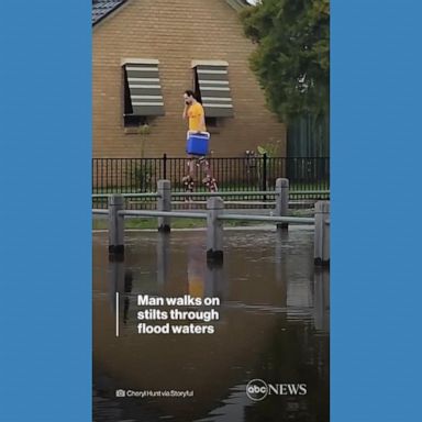 VIDEO: Man walks on stilts through flood waters