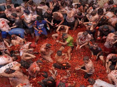 WATCH: Revelers paint the town red in Spain's annual tomato fight