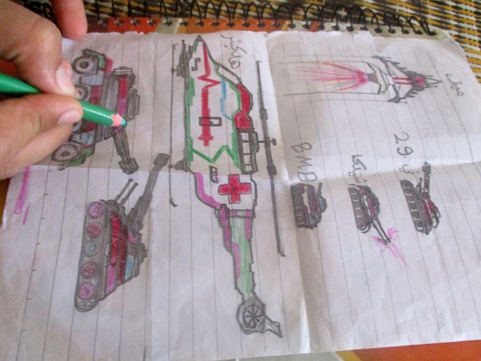 PHOTO: A child in the Za'atari refugee camp draws things she saw in Syria.