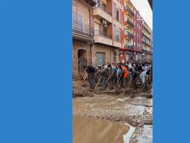 WATCH:  Volunteers sweep out water after deadly Spain floods