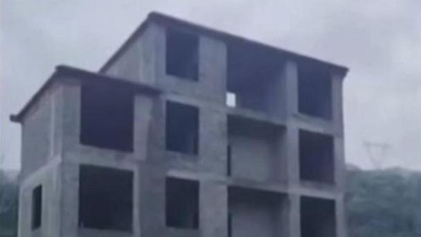 Five-story building collapses into river in southern China