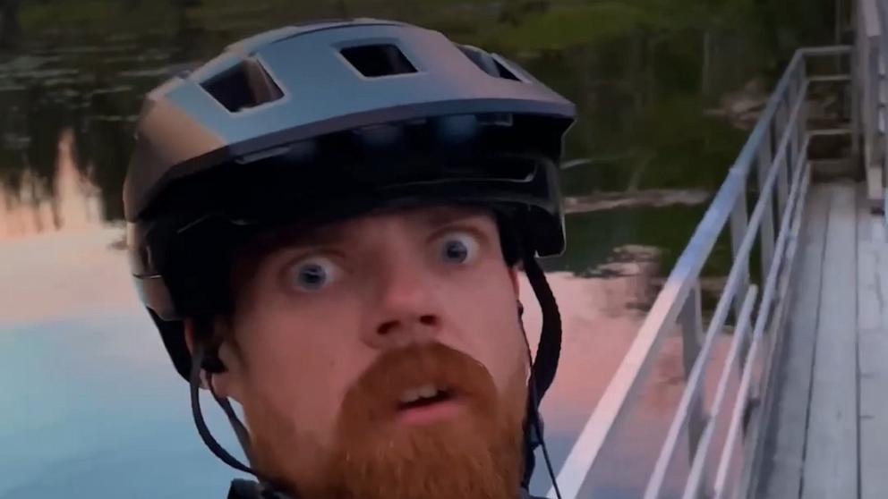 Cyclist has close encounter with bear crossing pedestrian bridge