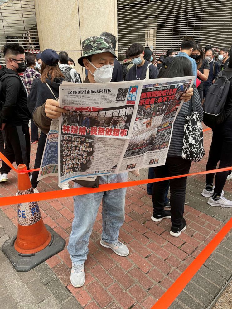 PHOTO: A supporter reads local paper Apple Daily, which has become a marker of the democracy movement.