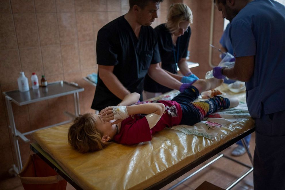 PHOTO: Yana Stepanenko, 11, has her wounds dressed by doctors at a hospital in Lviv, Ukraine, May 13, 2022. Yana and her mother Natasha were injured April 8 during shelling at the Kramatorsk train station.